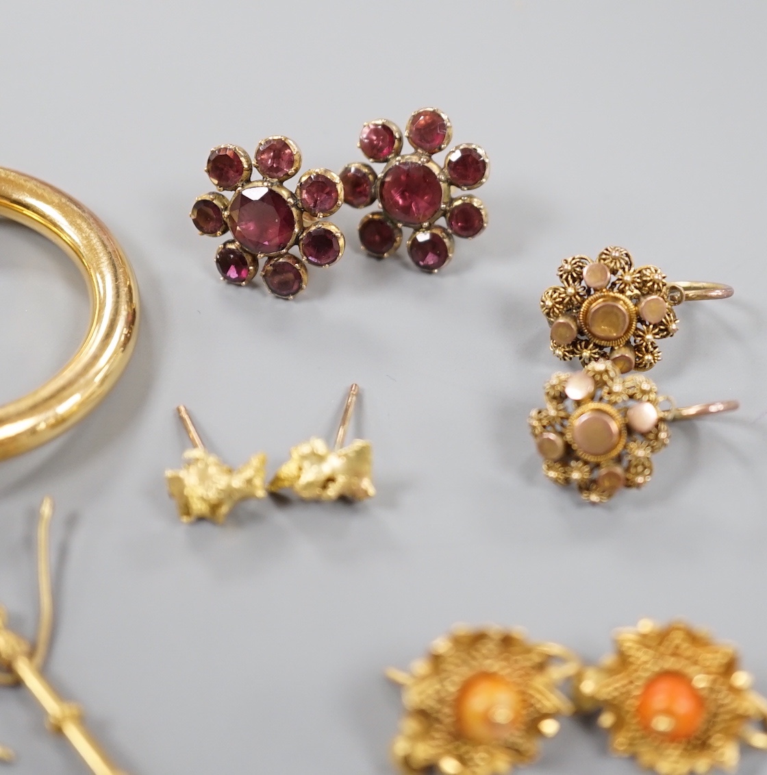 Eight assorted pairs of yellow metal or yellow metal and gem set earrings, including two pairs of Victorian garnet set, coral bead set, nugget and 9ct gold hoop